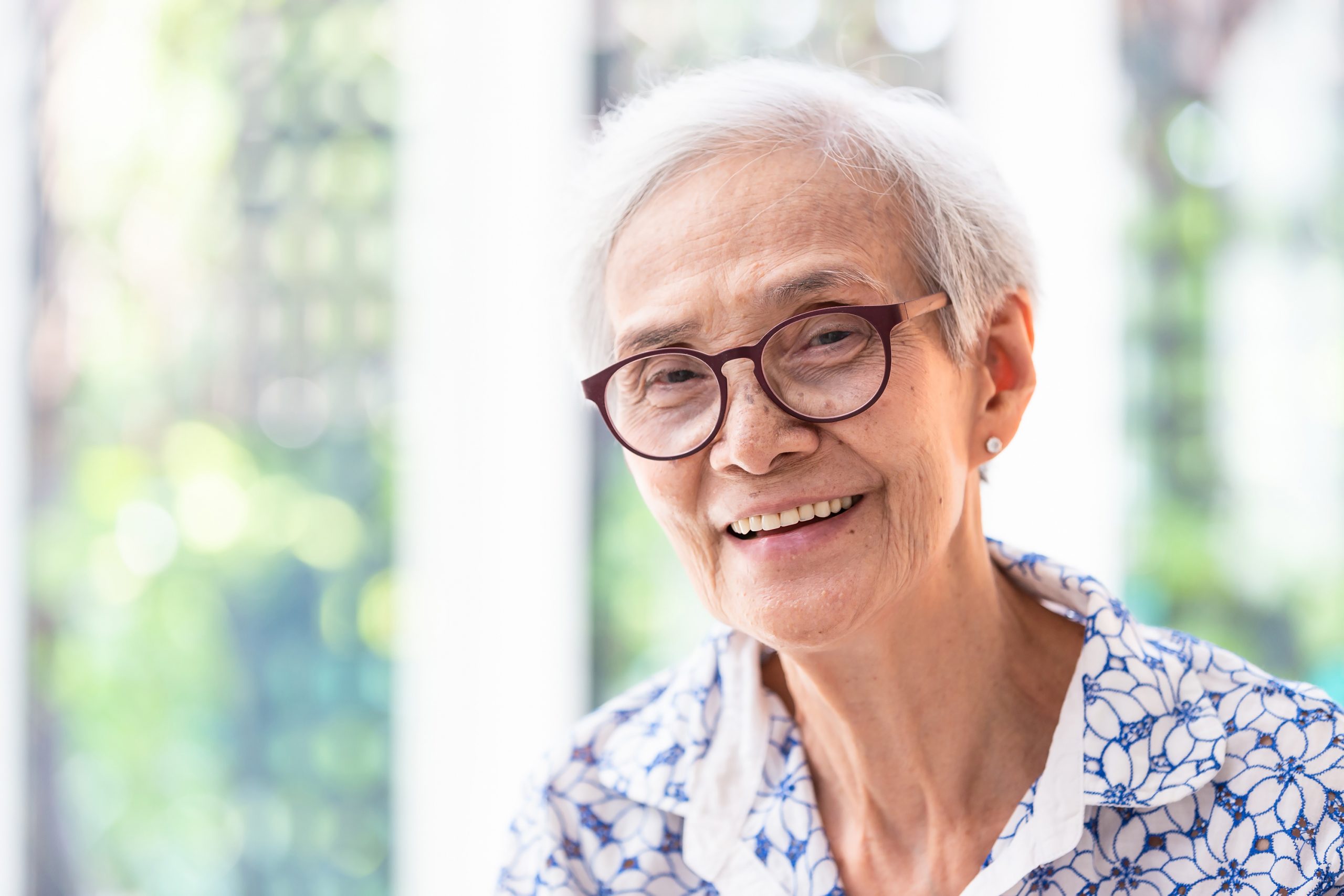 Close up asian elderly woman in glasses showing healthy straight